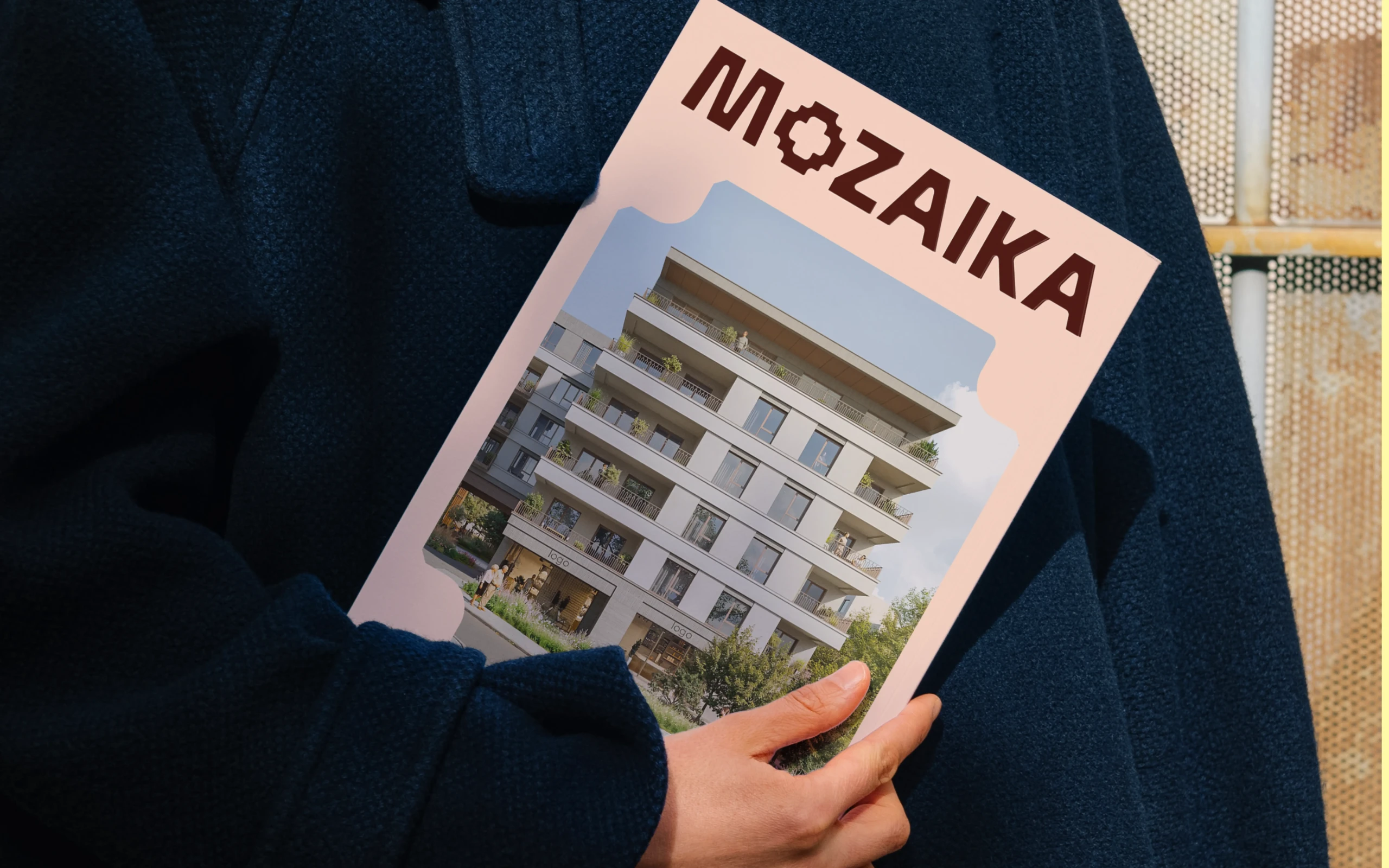 woman in dark blue coat holding magazine cover
